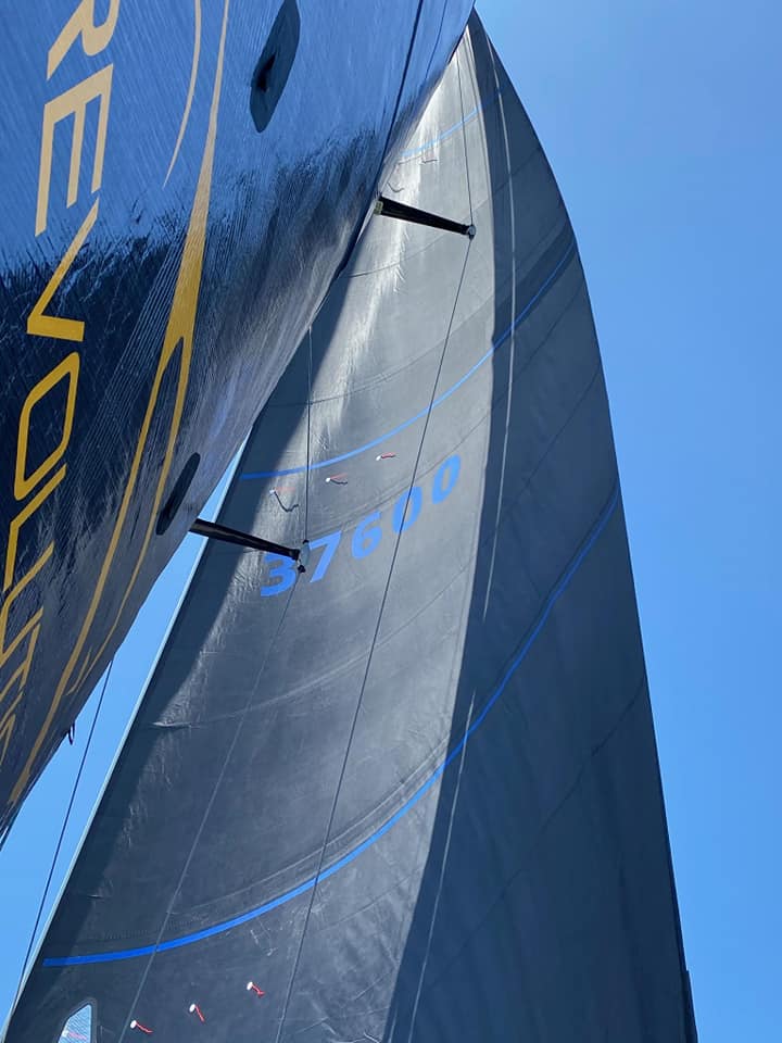 Close-up of sailboat sails against blue sky