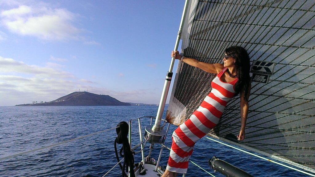 Woman sailing near island on sunny day