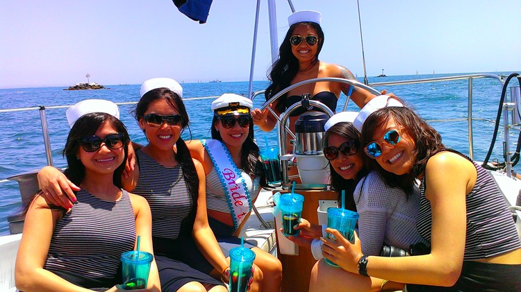 Group of women celebrating on a sailboat
