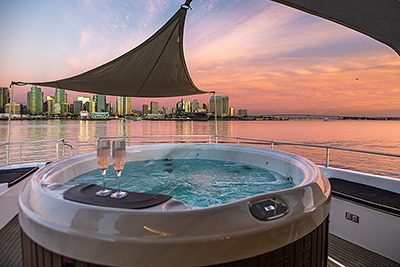 Hot tub on yacht overlooking city sunset