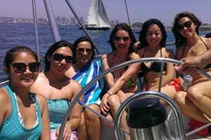 Group of friends enjoying sailing on sunny day