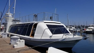 Modern white boat docked at marina