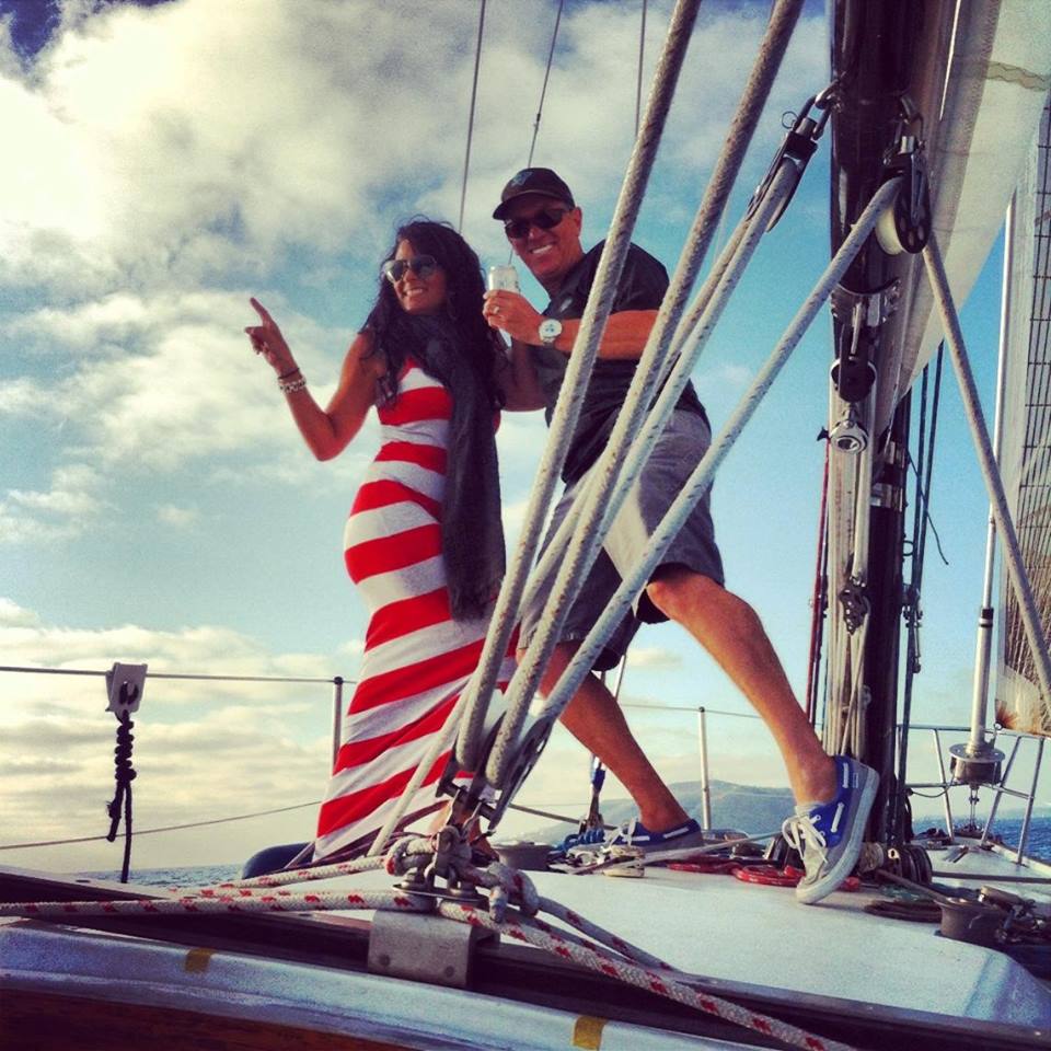 Couple enjoying sunny day on sailboat