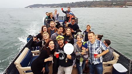Group of friends celebrating on a boat trip
