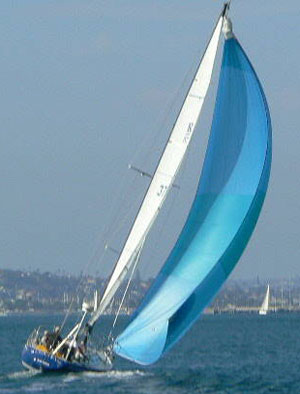 Sailboat with blue spinnaker sailing on ocean