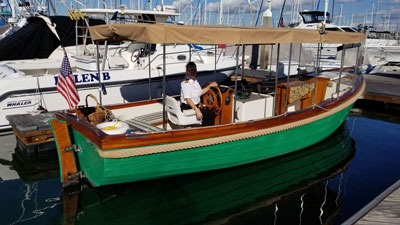Green motorboat docked at marina