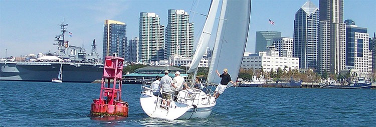 Sailboat near city skyline on sunny day