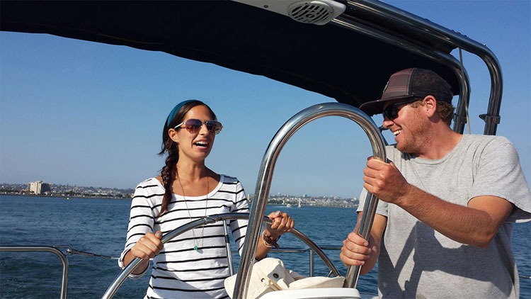 People smiling while sailing on a sunny day