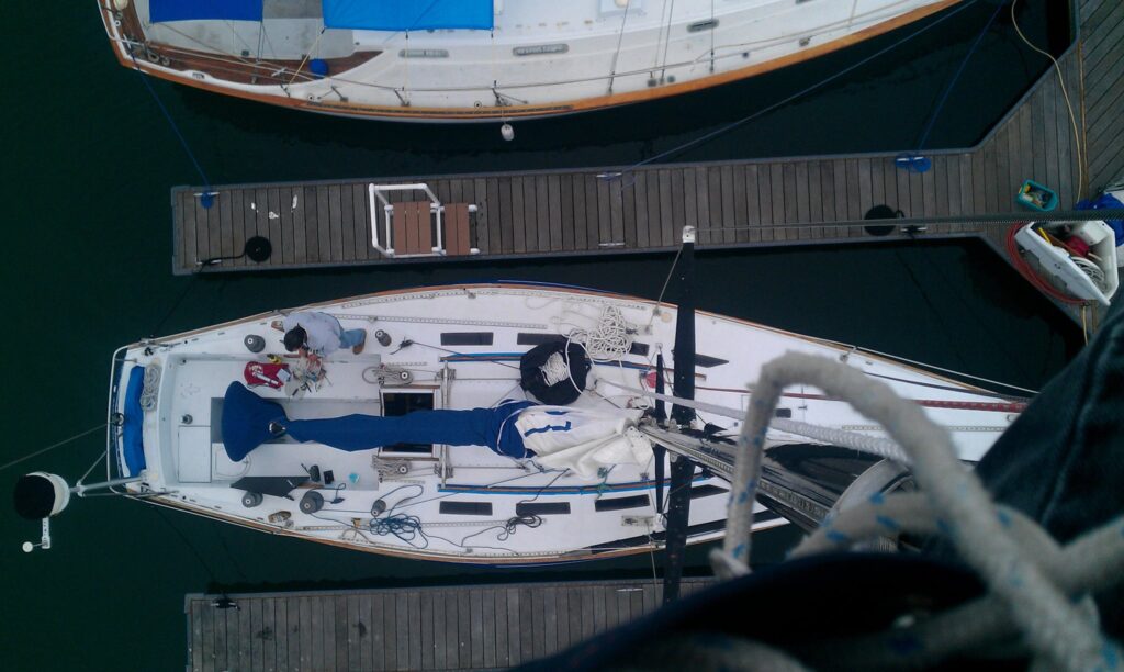 Sailboat docked with person working on deck