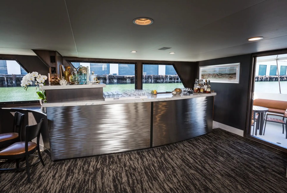 100_luxury_yacht_pacifica2 Luxurious yacht interior with modern bar setup.
