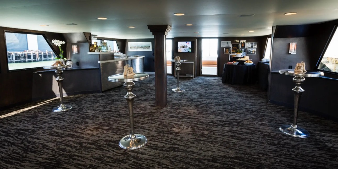100_luxury_yacht_pacifica7 Spacious event room with bar and tables.